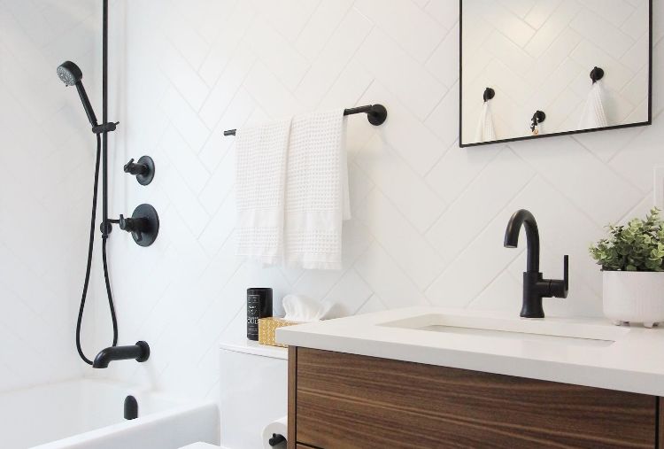 fresh white bathroom with matte black faucet and shower fixtures