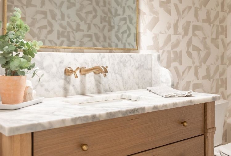 modern bathroom with wallpaper and champagne bronze hardware