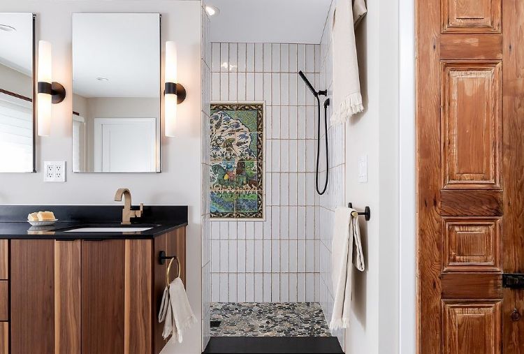 white bathroom with wood accents and matte black hand shower