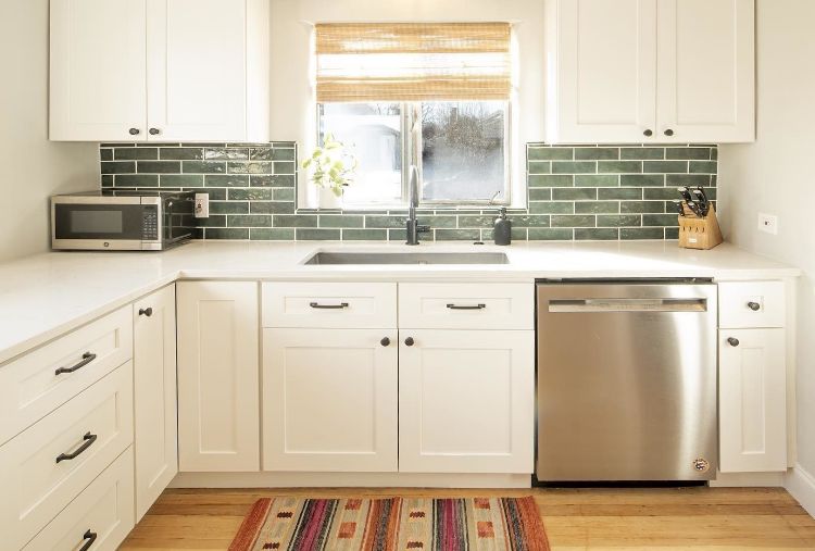 @row_homes' kitchen with green backsplash