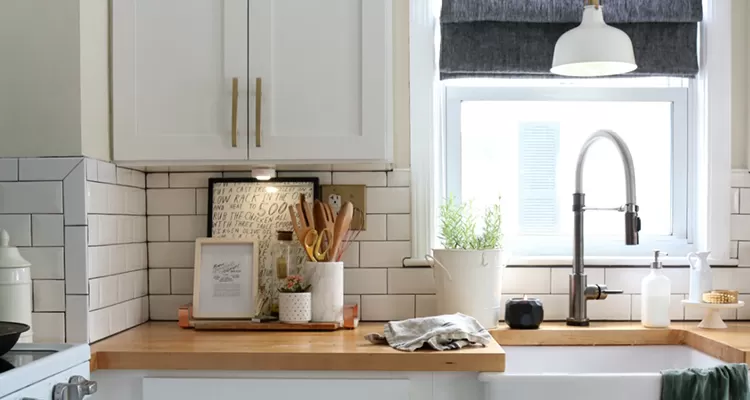 modern kitchen showing wood countertop and metal fixtures