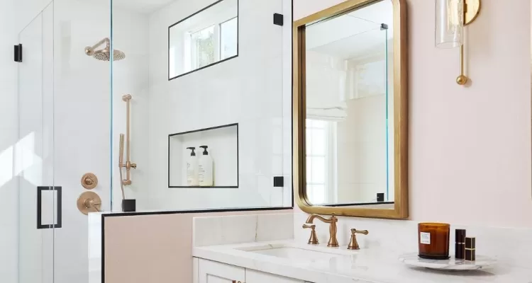 bright white bathroom with champagne bronze faucet and shower fixtures